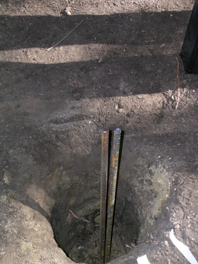 Posts slide over the rebar before cementing in place.