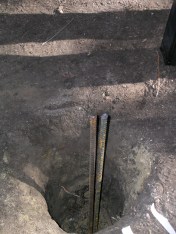 Posts slide over the rebar before cementing in place.