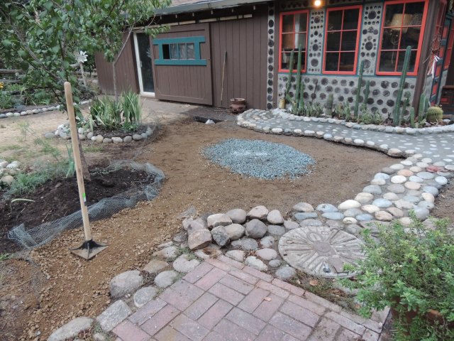 raked out with center marked with gravel for an outdoor oven